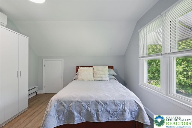 116 Peechatka, Pocono Twp, PA 18332 - bedroom featuring a baseboard radiator, vaulted ceiling, and light wood finished floors