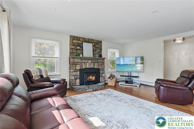 116 Peechatka, Pocono Twp, PA 18332 - living room with plenty of natural light, wood finished floors, a fireplace, and baseboard heating