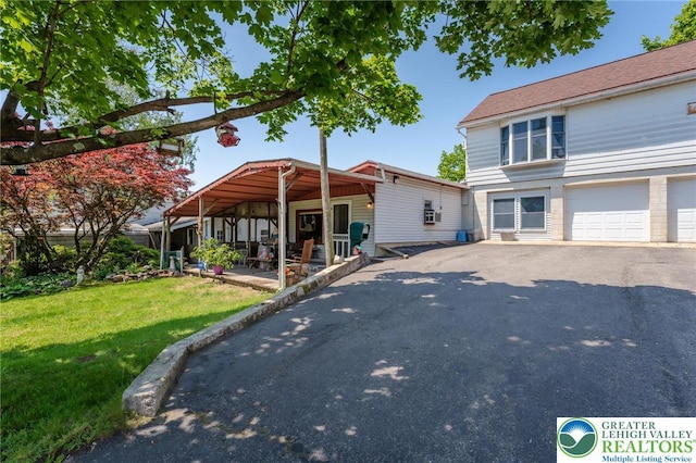 150 Lehigh St, Franklin Twp, PA 18235 - view of front of property with a front lawn, asphalt driveway, and a garage
