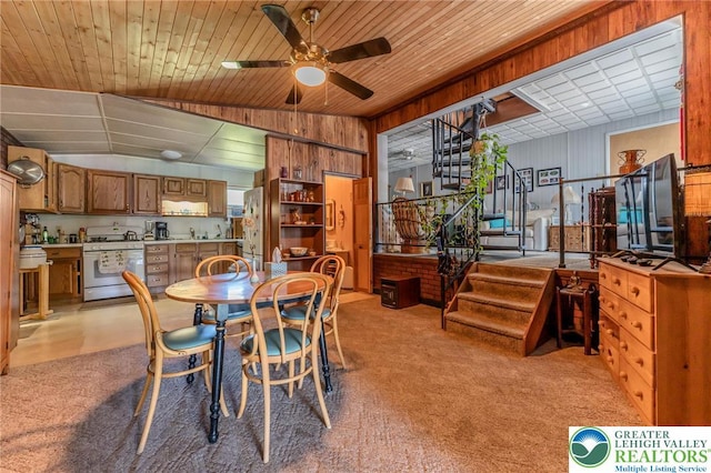 150 Lehigh St, Franklin Twp, PA 18235 - dining area featuring a ceiling fan, light carpet, stairway, wooden walls, and vaulted ceiling