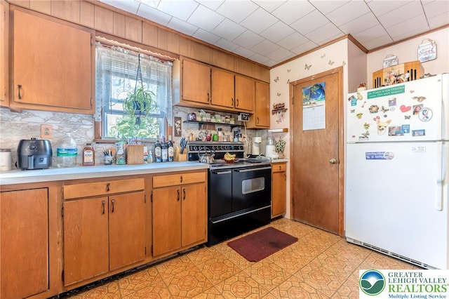 150 Lehigh St, Franklin Twp, PA 18235 - kitchen with freestanding refrigerator, black / electric stove, light countertops, tasteful backsplash, and ornamental molding