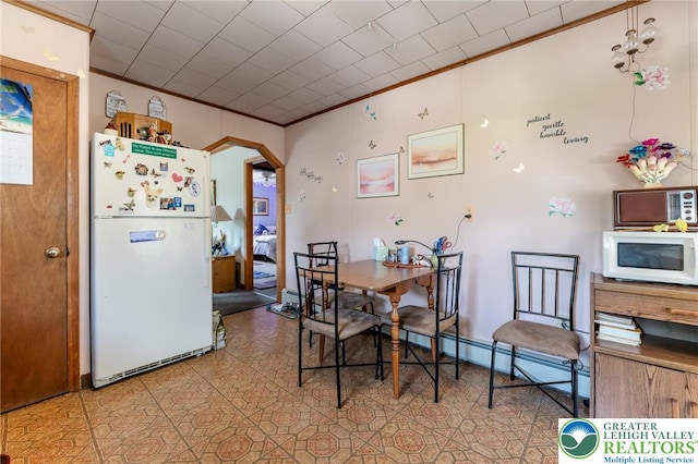 150 Lehigh St, Franklin Twp, PA 18235 - dining area with arched walkways, ornamental molding, and a baseboard heating unit