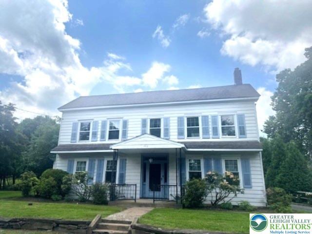 1512 River Rd, Bridgeton Twp, PA 18972 - view of front facade with a chimney, a porch, and a front yard