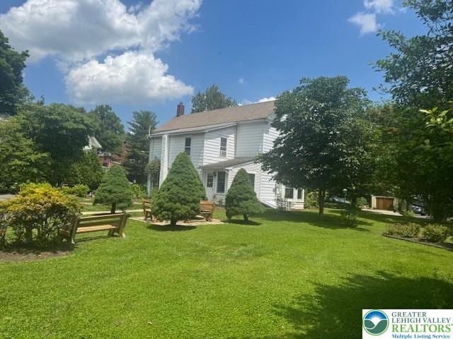 1512 River Rd, Bridgeton Twp, PA 18972 - back of house featuring a yard, a chimney, and entry steps