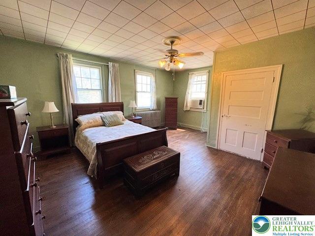 1512 River Rd, Bridgeton Twp, PA 18972 - bedroom featuring dark wood-style flooring, cooling unit, and ceiling fan