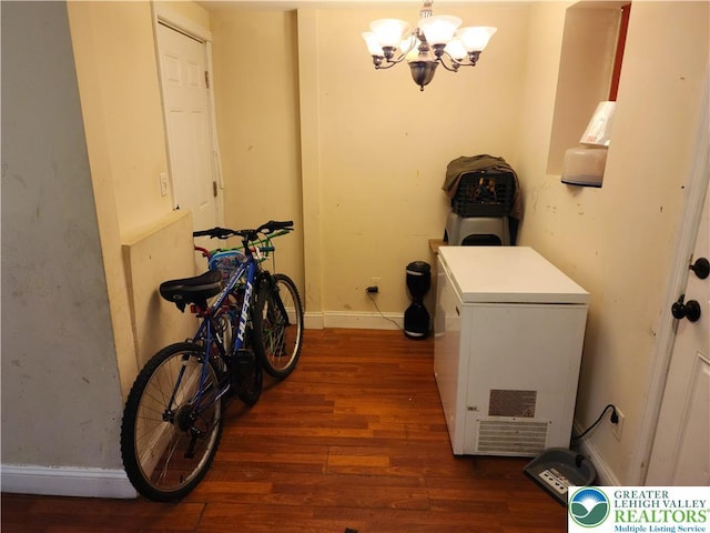 1016 Spruce St, Easton, PA 18042 - laundry area with wood finished floors, a chandelier, and baseboards