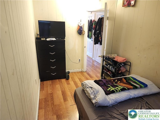 1016 Spruce St, Easton, PA 18042 - bedroom with light wood-type flooring and wood walls