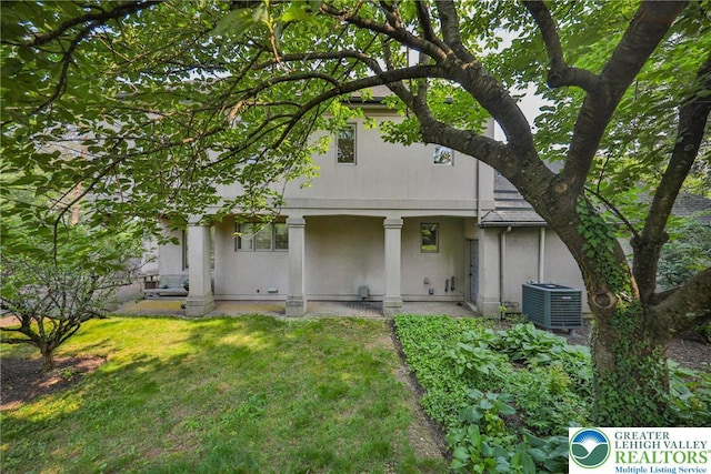 1731 Penns Xing, South Whitehall Twp, PA 18104 - back of property with central AC, a yard, and stucco siding