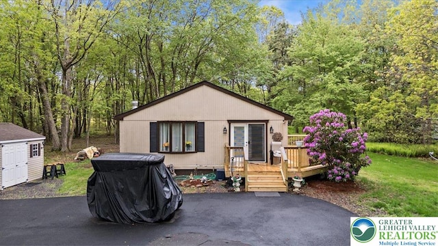 138 Drakes Dr, Penn Forest Twp, PA 18229 - view of front facade with a deck and view of wooded area