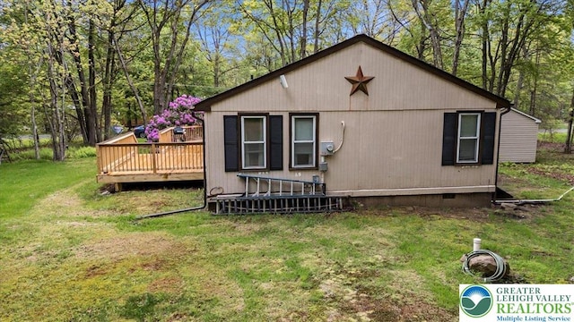 138 Drakes Dr, Penn Forest Twp, PA 18229 - view of property exterior featuring a wooden deck, a yard, and crawl space
