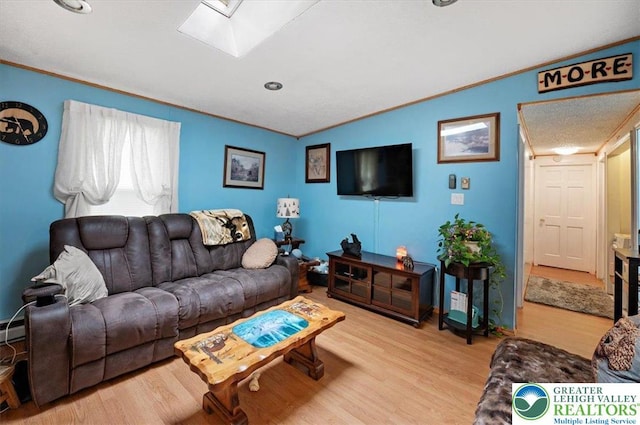 138 Drakes Dr, Penn Forest Twp, PA 18229 - living area with light wood-style flooring, crown molding, a skylight, and vaulted ceiling