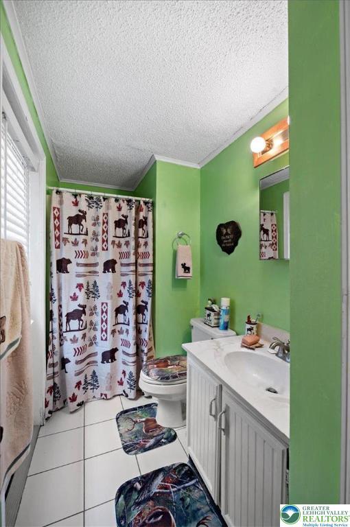 138 Drakes Dr, Penn Forest Twp, PA 18229 - full bathroom featuring a textured ceiling, vanity, toilet, crown molding, and tile patterned flooring