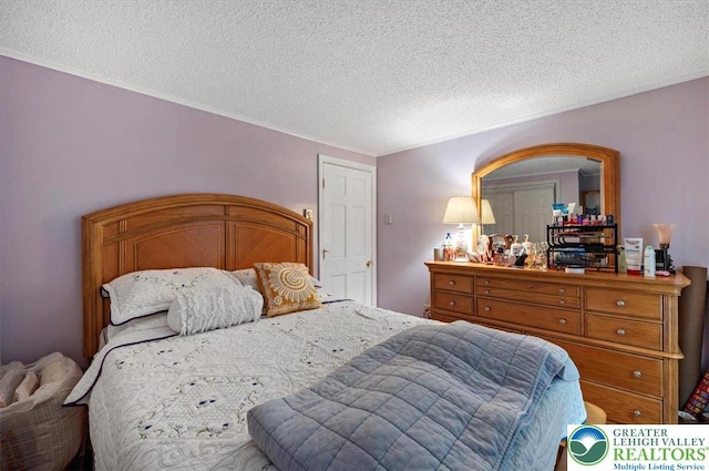 138 Drakes Dr, Penn Forest Twp, PA 18229 - bedroom featuring a textured ceiling and ornamental molding