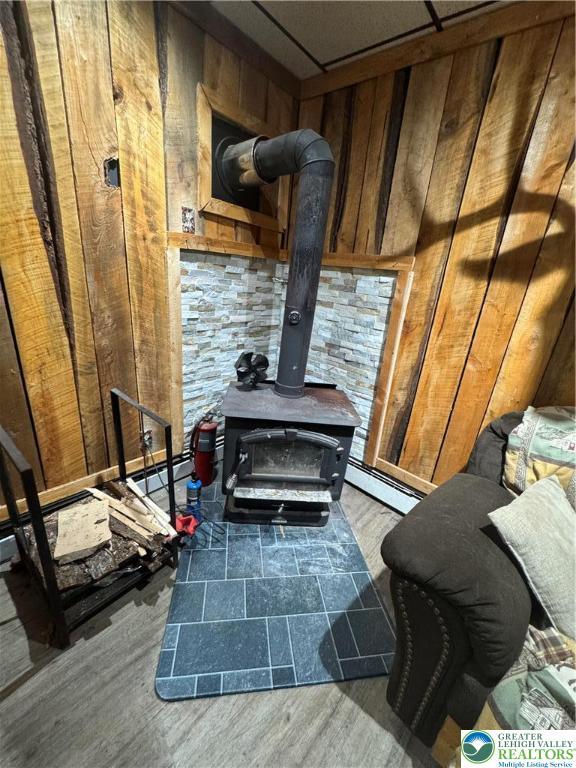2330 Long Run Rd, Franklin Twp, PA 18235 - detailed view of a wood stove, wood walls, and wood finished floors