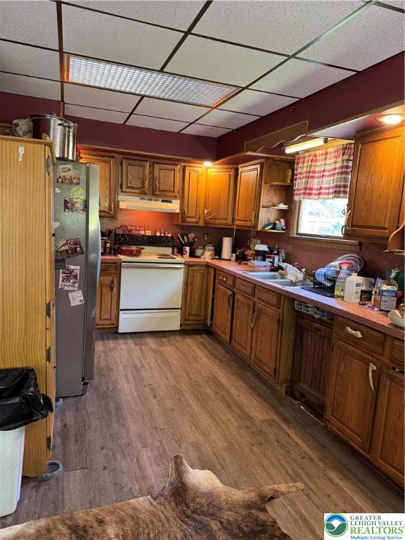2330 Long Run Rd, Franklin Twp, PA 18235 - kitchen with white range with electric stovetop, wood finished floors, freestanding refrigerator, under cabinet range hood, and brown cabinetry