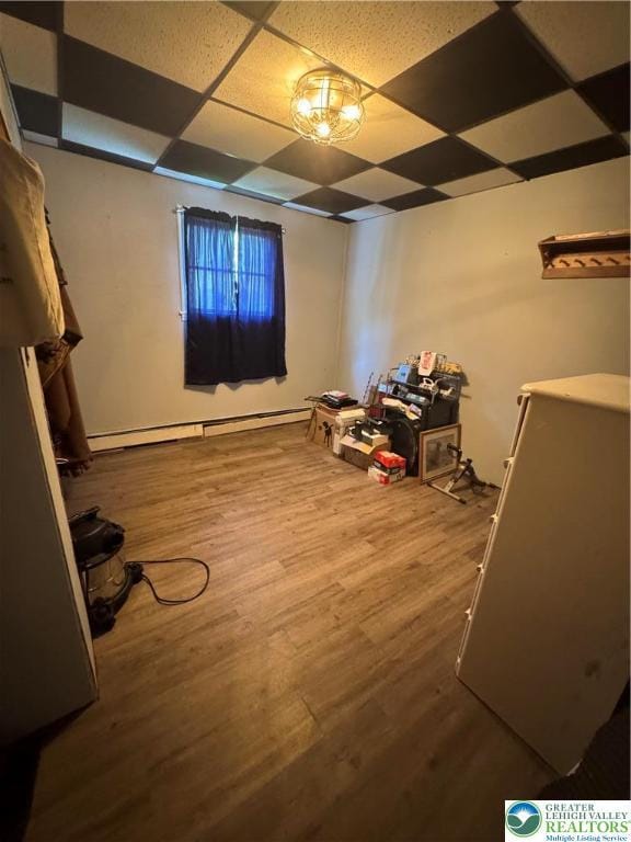 2330 Long Run Rd, Franklin Twp, PA 18235 - basement featuring a paneled ceiling, wood finished floors, and baseboard heating