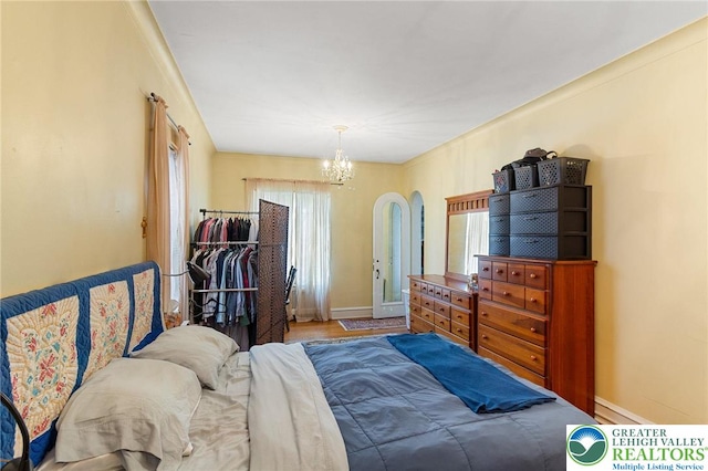 923 N Webster, Lackawanna, PA 18510 - bedroom with a chandelier, baseboards, wood finished floors, and arched walkways