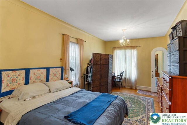923 N Webster, Lackawanna, PA 18510 - bedroom featuring multiple windows, wood finished floors, a chandelier, and baseboards