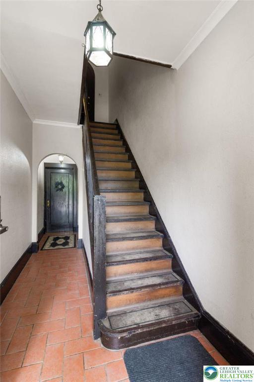 923 N Webster, Lackawanna, PA 18510 - stairway with ornamental molding, arched walkways, baseboards, and brick floors