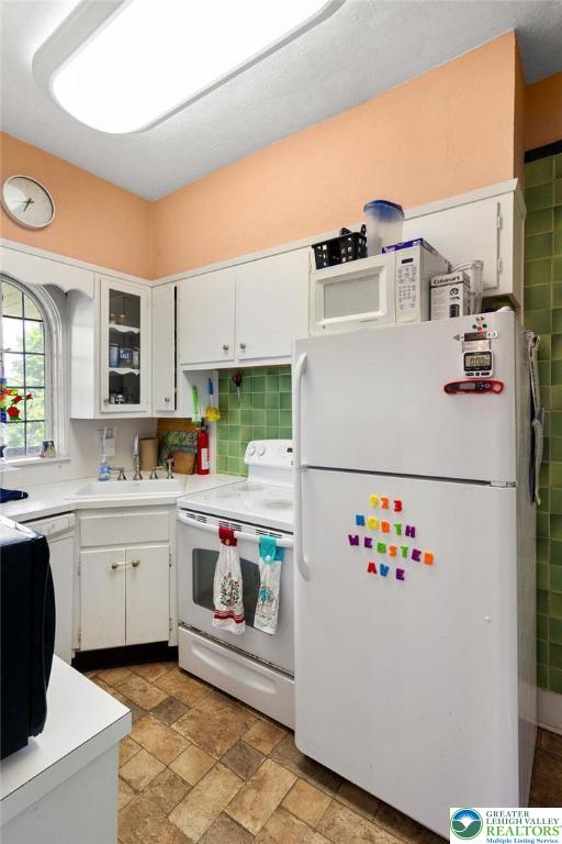 923 N Webster, Lackawanna, PA 18510 - kitchen featuring white appliances, white cabinets, a sink, light countertops, and stone finish flooring