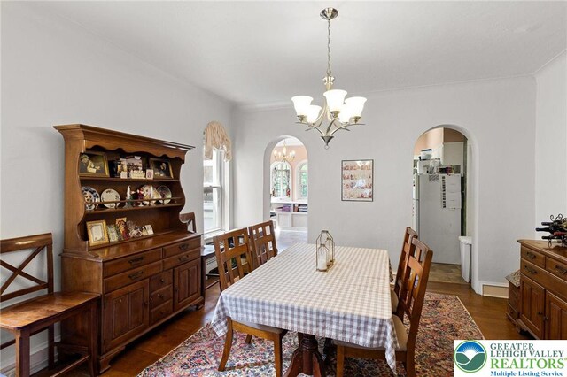 923 N Webster, Lackawanna, PA 18510 - dining room with arched walkways, a chandelier, and dark wood-style floors