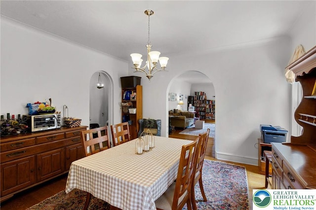 923 N Webster, Lackawanna, PA 18510 - dining room with arched walkways, a chandelier, wood finished floors, and baseboards