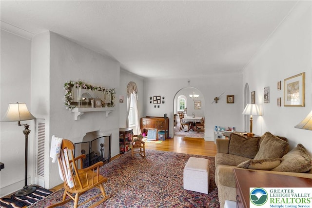 923 N Webster, Lackawanna, PA 18510 - living area with arched walkways, wood finished floors, and a chandelier
