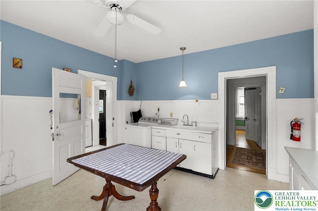 923 N Webster, Lackawanna, PA 18510 - kitchen featuring separate washer and dryer, light countertops, white cabinetry, ceiling fan, and hanging light fixtures