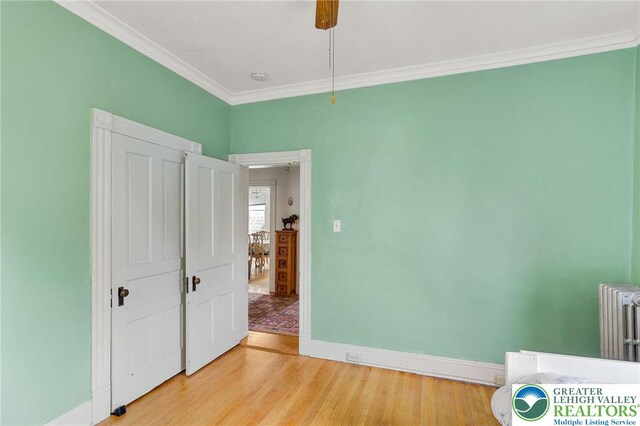 923 N Webster, Lackawanna, PA 18510 - unfurnished bedroom with light wood finished floors, baseboards, ornamental molding, radiator heating unit, and ceiling fan