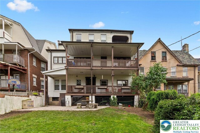 923 N Webster, Lackawanna, PA 18510 - back of house with a balcony, stucco siding, and a yard