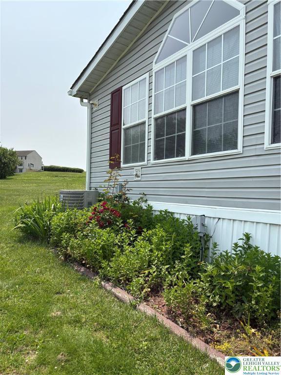 10188 Cork Ln, Upper Macungie Twp, PA 18031 - view of property exterior with central AC and a lawn