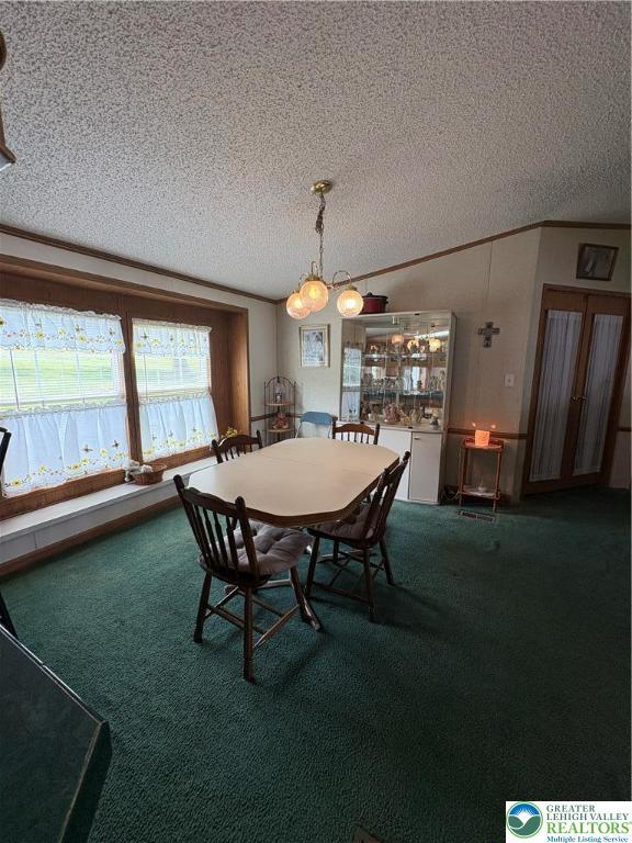 10188 Cork Ln, Upper Macungie Twp, PA 18031 - dining area featuring a textured ceiling, carpet floors, and crown molding