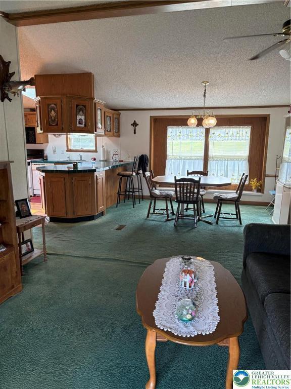 10188 Cork Ln, Upper Macungie Twp, PA 18031 - living area featuring light carpet, ceiling fan, and a textured ceiling