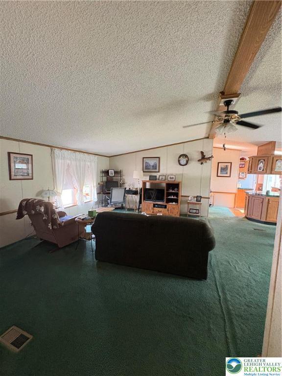 10188 Cork Ln, Upper Macungie Twp, PA 18031 - living area with a textured ceiling, ceiling fan, vaulted ceiling, and carpet