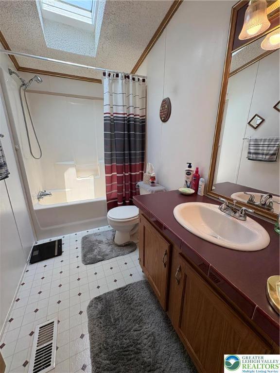 10188 Cork Ln, Upper Macungie Twp, PA 18031 - full bath featuring a skylight, vanity, shower / bath combination with curtain, toilet, and tile patterned floors