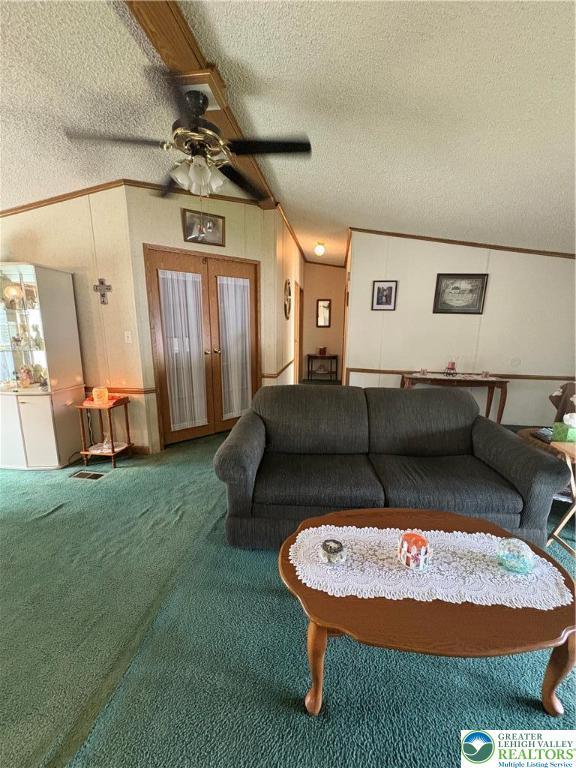 10188 Cork Ln, Upper Macungie Twp, PA 18031 - living area featuring a textured ceiling, carpet, french doors, a ceiling fan, and ornamental molding
