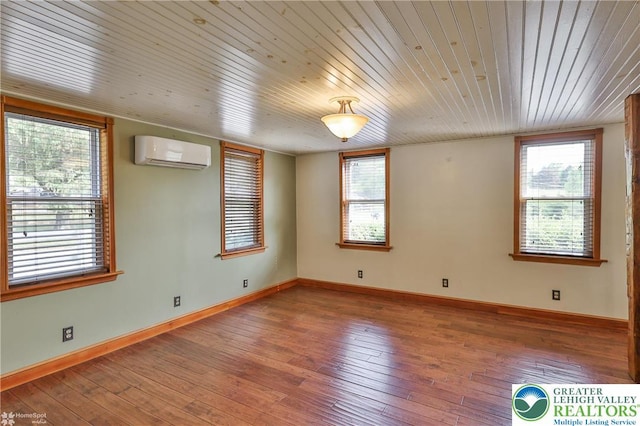 3679 Friedens Rd, Washington Twp, PA 18080 - spare room with a wall unit AC, wood ceiling, hardwood / wood-style flooring, and baseboards