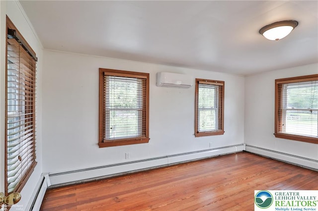 3679 Friedens Rd, Washington Twp, PA 18080 - spare room with a wall unit AC and wood finished floors