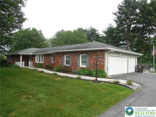 3554 Magnolia Dr, Bethlehem Twp, PA 18045 - single story home featuring asphalt driveway, a garage, brick siding, and a front lawn