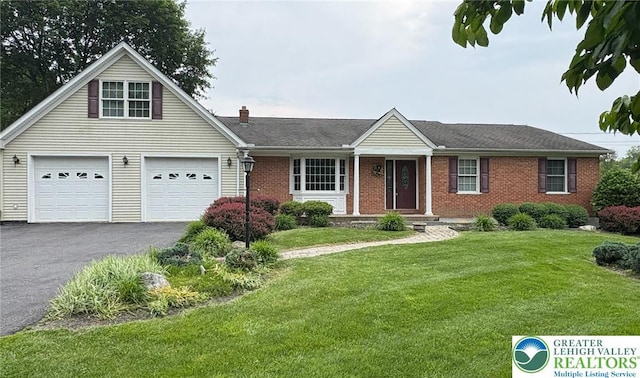 480 Park Rd, Upper Mt Bethel Twp, PA 18013 - view of front of house with asphalt driveway, brick siding, a front lawn, a chimney, and a garage