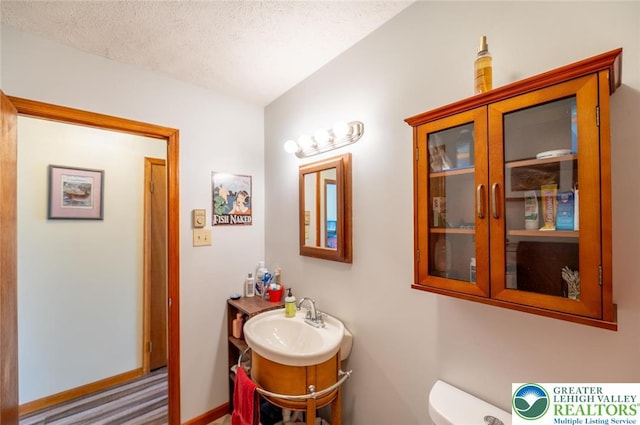 354 Kilmer Trl, Penn Forest Twp, PA 18210 - half bath with vanity, toilet, a textured ceiling, and baseboards