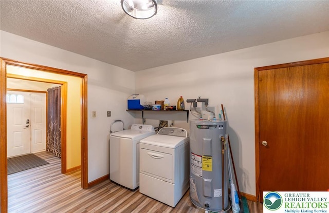 354 Kilmer Trl, Penn Forest Twp, PA 18210 - laundry room featuring water heater, washer and clothes dryer, light wood-style flooring, a textured ceiling, and baseboards