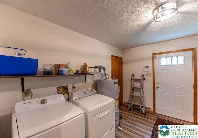 354 Kilmer Trl, Penn Forest Twp, PA 18210 - laundry area featuring water heater, washing machine and dryer, wood finished floors, and a textured ceiling