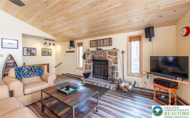354 Kilmer Trl, Penn Forest Twp, PA 18210 - living room with a baseboard heating unit, healthy amount of natural light, lofted ceiling, wood finished floors, and a stone fireplace