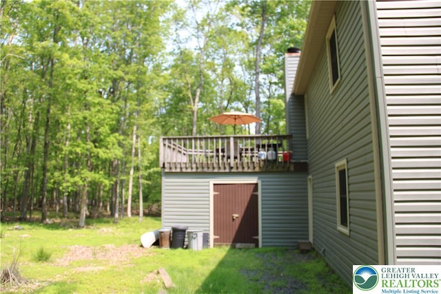 354 Kilmer Trl, Penn Forest Twp, PA 18210 - view of green lawn with a wooden deck and view of scattered trees
