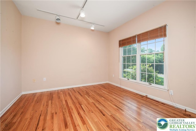 730 Buttermilk Rd, Williams Twp, PA 18055 - unfurnished room with rail lighting, light wood finished floors, and baseboards