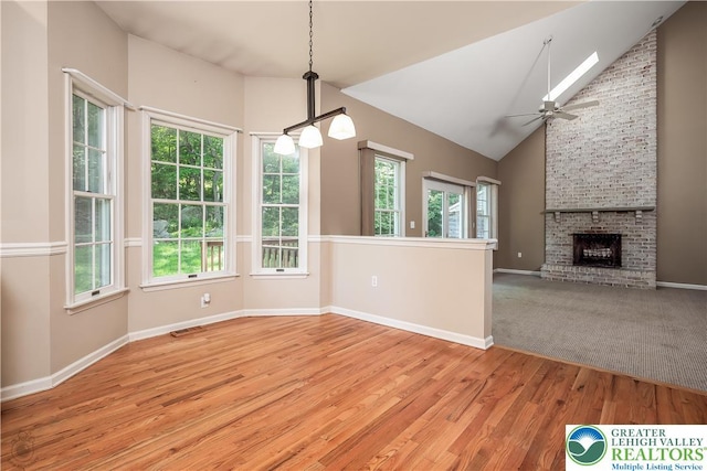 730 Buttermilk Rd, Williams Twp, PA 18055 - unfurnished dining area featuring healthy amount of natural light, light wood-style floors, ceiling fan, a fireplace, and high vaulted ceiling