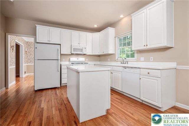730 Buttermilk Rd, Williams Twp, PA 18055 - kitchen featuring white appliances, white cabinetry, light wood-type flooring, a center island, and light countertops