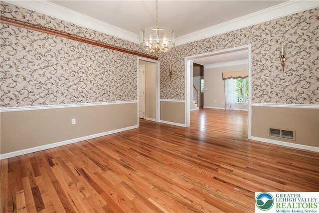 730 Buttermilk Rd, Williams Twp, PA 18055 - spare room featuring a chandelier, wallpapered walls, light wood-style floors, crown molding, and stairway
