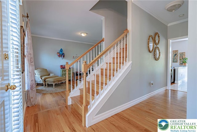 697 Ryan Dr, South Whitehall Twp, PA 18103 - stairway featuring crown molding, wood finished floors, and baseboards